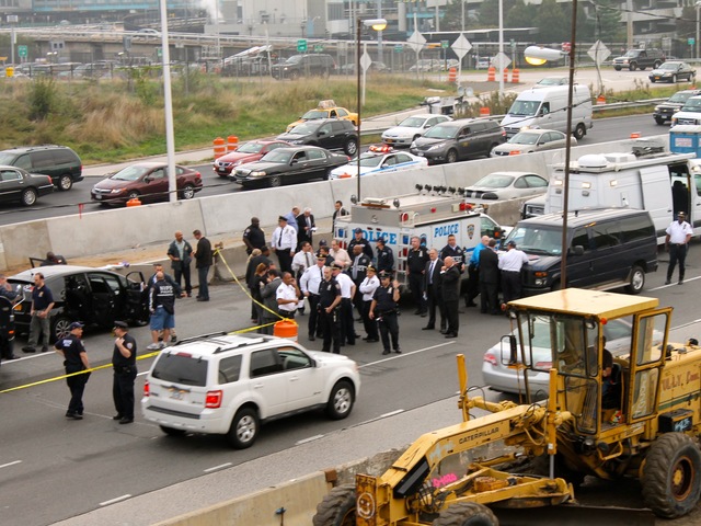 <p>Police investigate in the aftermath of a shooting on the Grand Central Parkway on Oct. 4, 2012.</p>

