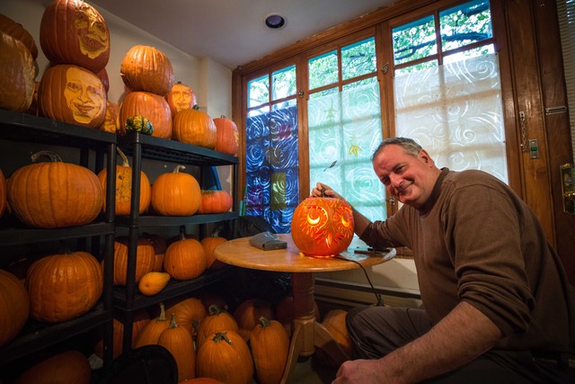 <p>Hugh McMahon and his final product: an owl from the pumpkin</p>
