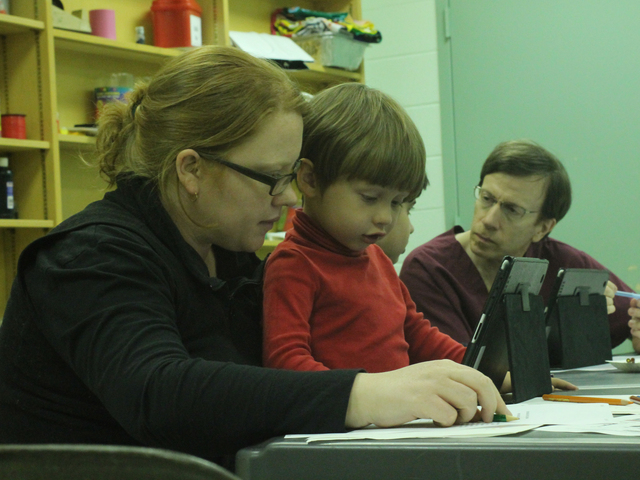 <p>A mother and her child create a story during the Autism Initiatives iPad storytelling class at the Forest Park Library on Oct. 1, 2012.</p>
