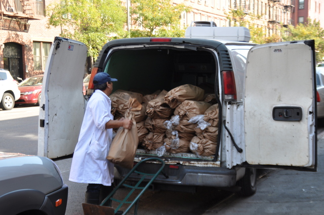 <p>A worker at the poultry slaughterhouse loaded a van with chickens.</p>
