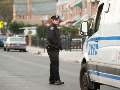 <p>A police officer at the scene of a fatal shooting on Hemlock Street. Photo taken on Tuesday October 23rd, 2012.</p>

