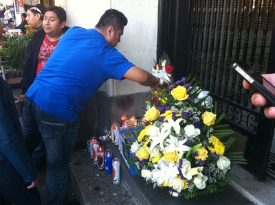 <p>Mourners gather after the death of Francisco Pinzon-Martinez, 30, at a Metro PCS store in Hamilton Heights on October 19, 2012.</p>
