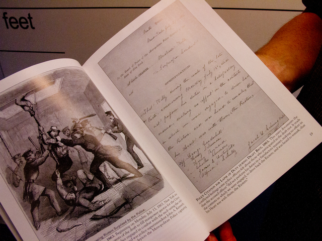 <p>Michael Cronin, a&nbsp;former NYPD detective, shows a photo illustration Oct. 5, 2012 from a new book he co-authored, titled "New York City Police." The document is a list characterization and specifications during the draft riots dating back to 1863, and has never been previously published.</p>
