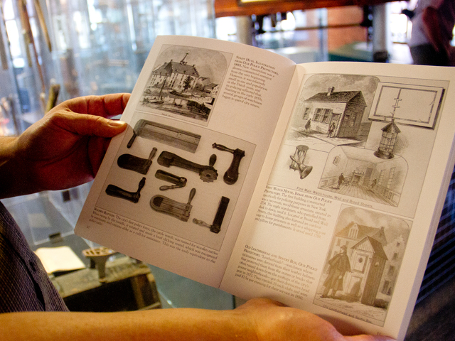 <p>Michael Cronin, a&nbsp;former NYPD detective, shows several of photo illustrations Oct. 5, 2012 from a new book he co-authored, titled "New York City Police."</p>
