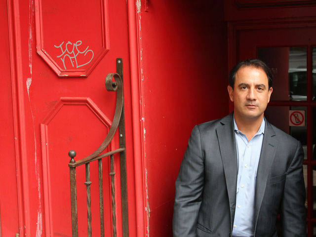 <p>Peter Coundouris stands outside his new restaurant, Park West, which he said will open in December.</p>
