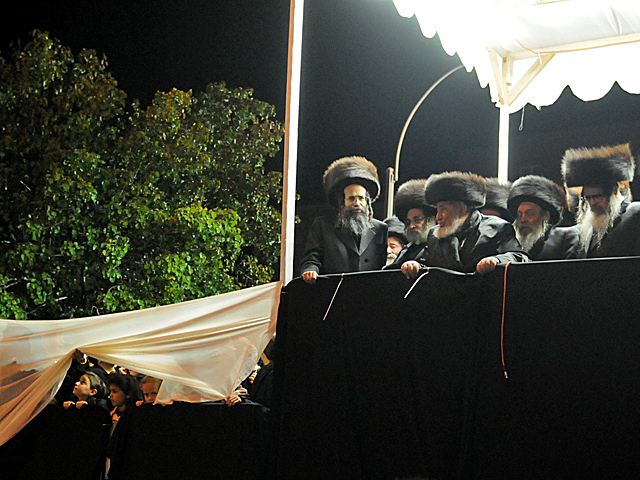 <p>Family members sat on a podium along Bedford Avenue for the wedding of Chaim Hersch Rosenberger and Classoner Rav Scher, Oct. 17, 2012.</p>
