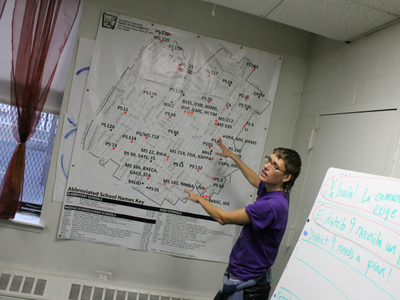 <p>A New Settlement PAC organizer shows a map of District 9. The red dots represent schools the state has identified as struggling.</p>
