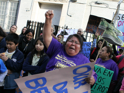 <p>A parent leads a chant.</p>
