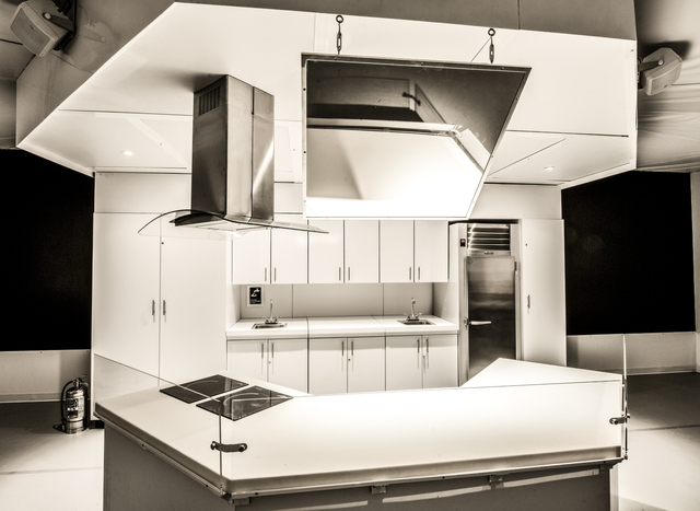 <p>Our Global Kitchen features a 735-square-foot, custom-designed kitchen in the center of the exhibition. The center island holds two convection cooktops and an exhaust hood. The kitchen also features a venting unit, portable sinks and a professional-grade refrigerator. A hanging mirror allows viewers to see demonstrations on the counter surface.</p>
