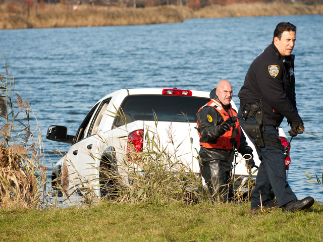 <p>Officers work to remove the pickup from Meadow Lake in Forest Hills Monday morning, Nov. 19, 2012.</p>
