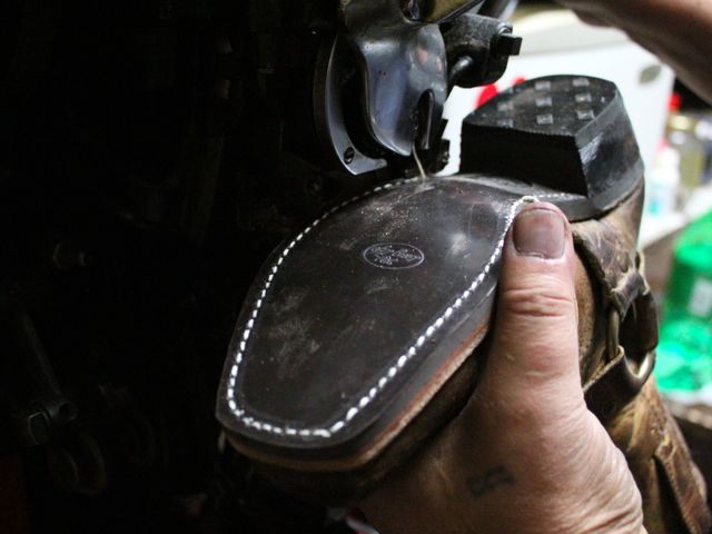 <p>Shalom Dekhkanov uses an industrial sewing machine to attach a new sole to a boot.</p>
