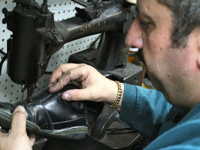 <p>Erik Shoe Repair is full of shoes on the mend, products and equipment, such as a 1929 manually operated Singer sewing machine.</p>
