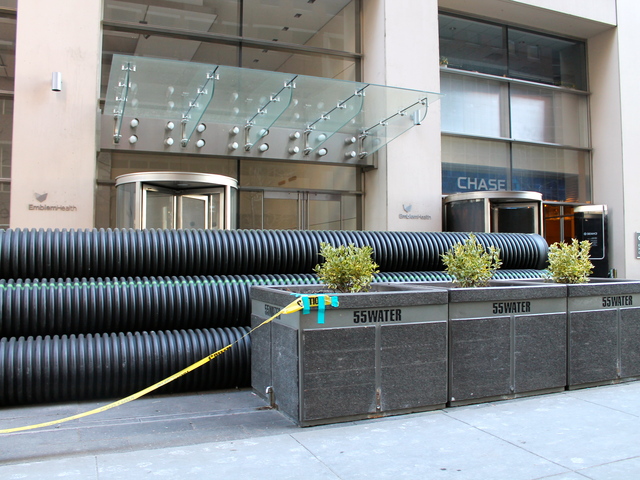 <p>Yellow caution tape was blocking off 55 Water Street on Wednesday. Tenants there include the offices of Standard and Poor's and the corporate headquarters for Emblem Health.</p>
