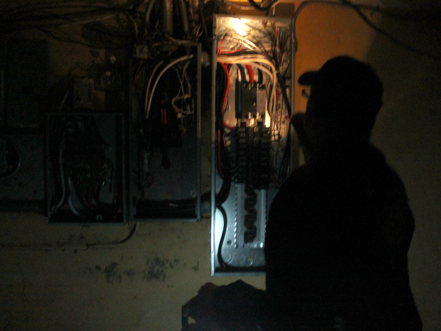 <p>Army veteran Eddie Acosta checks circuit breakers in the basement of VFW Post 5195 in Red Hook. The post sustained serious flooding and damage during Hurricane Sandy.</p>
