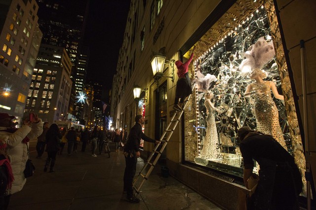 <p>Staffs at Bergdorf Goodman's put some final touch on its windows before the unveiling on Nov. 20</p>
