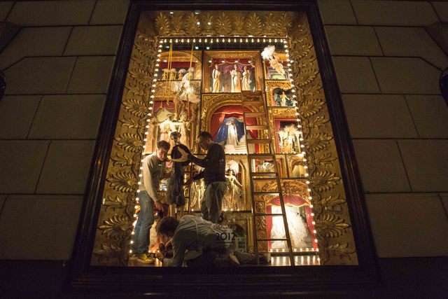 <p>Staffs at Bergdorf Goodman's put some final touch on its windows before the unveiling on Nov. 20</p>
