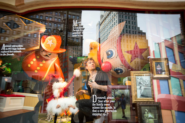 <p>A worker at Macy's does some fixing to one of its windows on Nov. 19</p>
