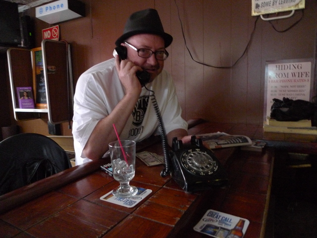 <p>Mark McFarland, a regular at Jackie's Fifth Amendment, demonstrates the functioning rotary phone at the longtime watering hole on Fifth Avenue and Seventh Street.</p>
