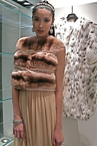 <p>Cream silk chiffon gown and blush pink chinchilla vest with Swarovski crystals and pearls.</p>

