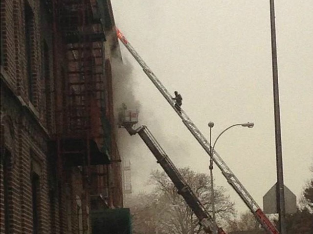<p>A fire fighter battles a blaze at Midwood High School on Tuesday November 27, 2012.</p>
