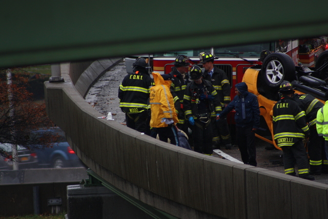 <p>Two people were hurt when a taxi overturned on a ramp leading to the Long Island Expressway Nov. 27, 2012.</p>
