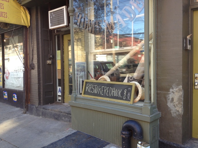 <p>Homemade co-owner Monica Byrne placed a sign for Restore Red Hook in the front window of the restaurant.</p>
