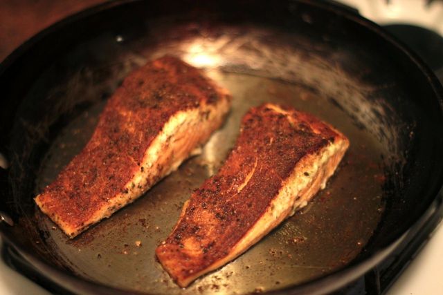 <p>Salmon is seared on both sides before being placed in the oven to finish.</p>
