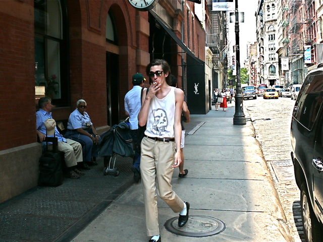 <p>Evoking Michael Jackson, a svelte guise fashioned with a sleeveless T-shirt, cropped pants, white socks, black loafers and mirrored lenses.<br />
	&nbsp;</p>

