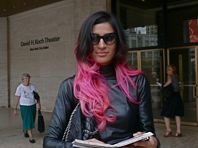 <p>Stylist Elena Moussa in a black leather turtleneck dress and colored locks.</p>
