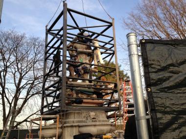 The controversial monument was moved out of Kew Gardens and installed in a Brooklyn cemetery on Monday.