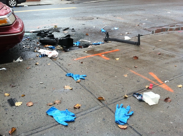 <p>Debris from the crime scene where Chenugor Dao, 60, was killed when standing on the corner with 3 others when two SUVs collided in Gravesend.</p>
