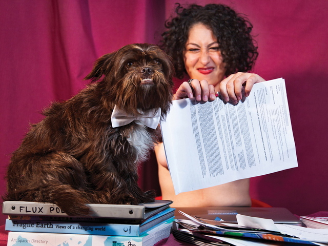 <p>Flux Factory executive director Christina Vasallo poses as a sultry Ms. April who rails against the IRS by ripping up her faux tax bills, along with Flux mascot pup Truman.</p>
