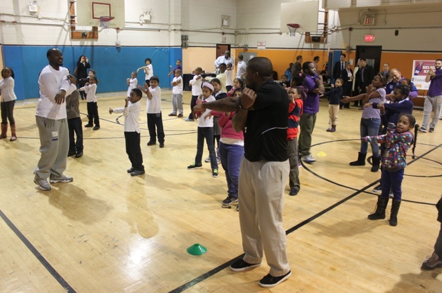 <p>Hakeem Nicks stretches with kids from Union Settlement.</p>
