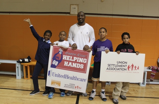 <p>Hakeem Nicks with kids from Union Settlement in East Harlem. The kids will get backpacks filled with healthy food to take home on Fridays.</p>
