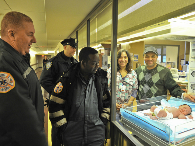 <p>Abdel Elkarhat showed off his newborn son, Nassim, as Port Authority Tunnel and Bridge Agents George McCann (left) and Jean Bernard look on. The child was born in the Holland Tunnel on Wednesday, Dec. 26, 2012.</p>
