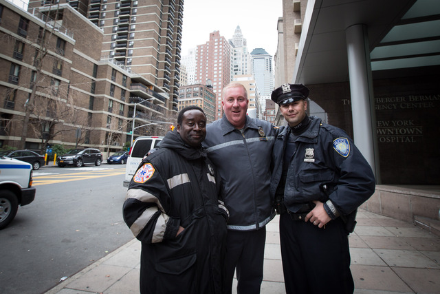<p>Port Authority agents George McCann (center) and his partner Jean Bernard (on his left) helped deliver a baby baby in Holland Tunnel on Dec. 26, 2012.</p>
