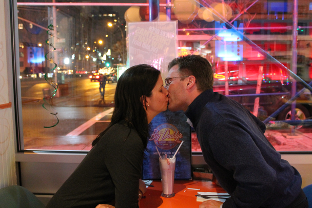 <p>The couple shares a kiss at the table where they got engaged.</p>
