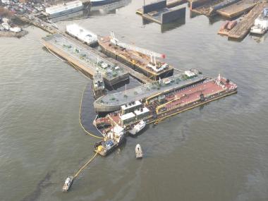 A barge spilt fuel oil into the Kill Van Kull, which spread to Shooter's Island, on Friday.