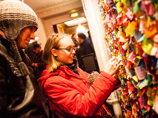 <p>Luke Kingston, 22, from Australia and girlfriend Annie Willat, 21, pin their confetti wishes on the New Year's Eve Wishing Wall at the Times Square Museum on Dec. 29th, 2012.</p>
