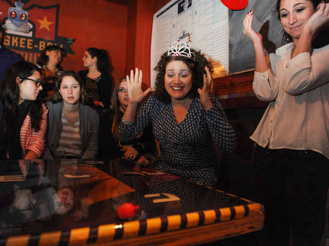 <p>Nora Endlich, in princess crown, reacts to her opponent's dreidel move at the competition.</p>
