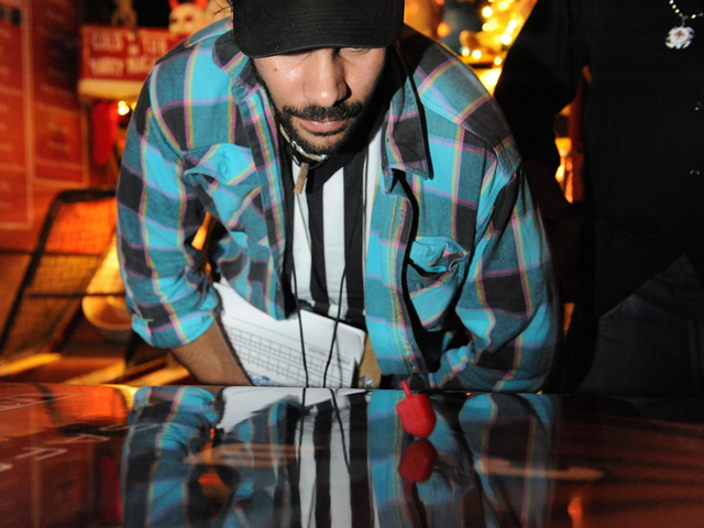 <p>Eric Pavoney, "The Knishiner," rules on the point-scoring of a dreidel spin.</p>
