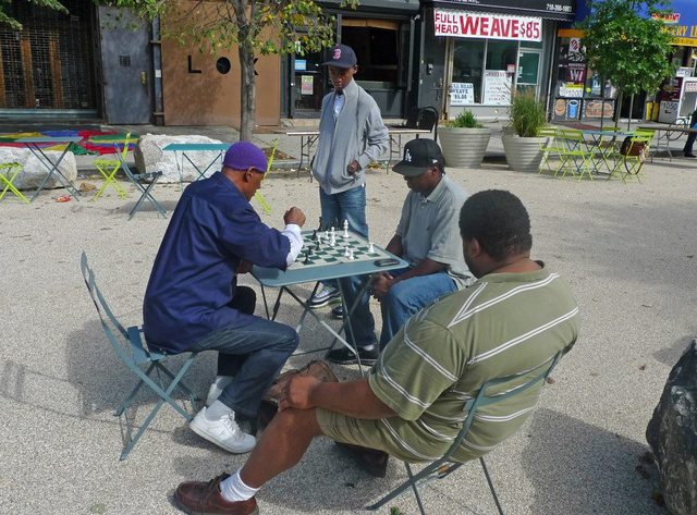 <p>At another plaza in Brooklyn, Putnam Triangle Plaza at Putnam Avenue, men play chess at the tables.&nbsp;</p>
