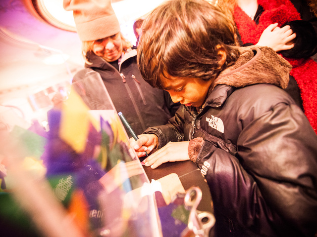 <p>Ryan Stokes, 6, from Charlotte, North Carolina, writes his New Year's wish on a piece of confetti at the Times Square Museum on Dec. 29th, 2012.</p>
