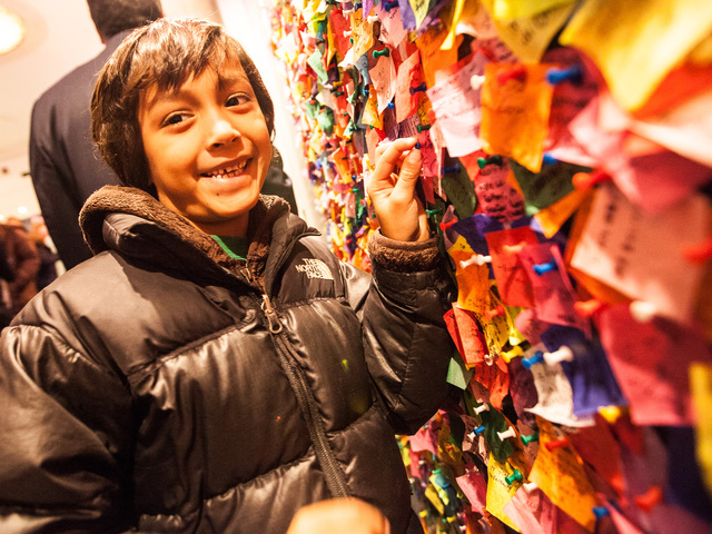 <p>Ryan Stokes, 6, from Charlotte, North Carolina, pins his confetti wish on the New Year's Eve Wishing Wall at the Times Square Museum on Dec. 29th, 2012.</p>
