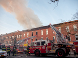 Firefighters Rescue Women Dangling from Window in Burning Building