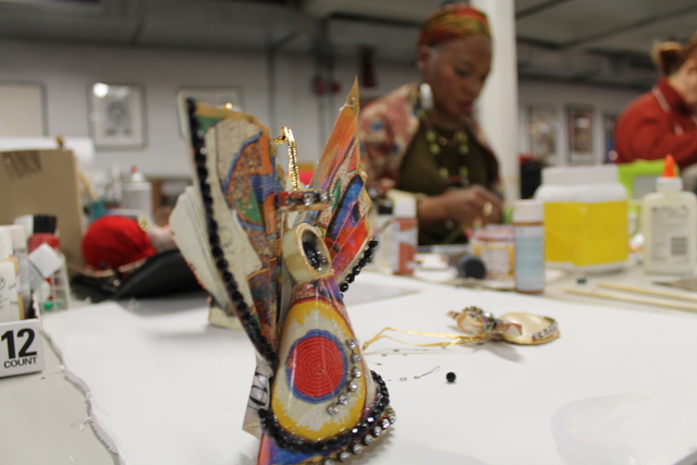 <p>Donna Brew, 58 sat in the organization's loft space at the Mink Building on 126th Street in West Harlem making paper angels for old calendars and shells.</p>
