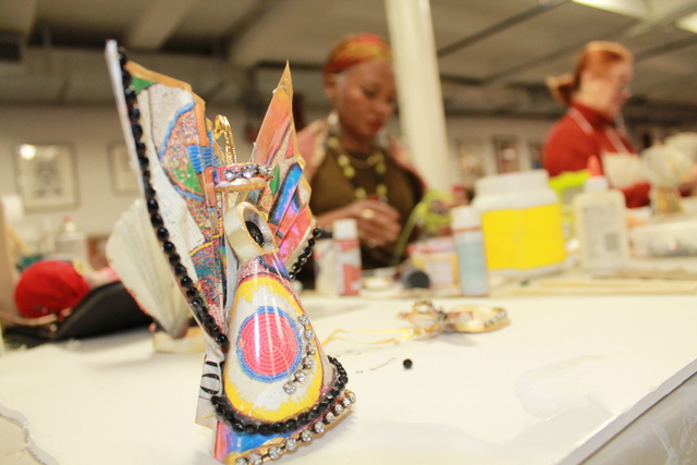 <p>Donna Brew, 58 sat in the organization's loft space at the Mink Building on 126th Street in West Harlem making paper angels for old calendars and shells.</p>
