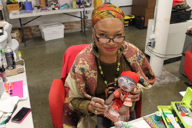<p>Artists Donna Brew with one of her creations at SoHarlem</p>
