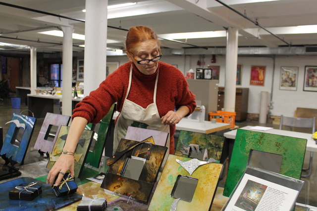 <p>Artisan Gladys Rosa Perez with some of her painted plexiglass creations.</p>
