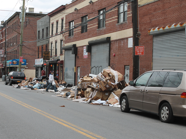 <p>A man walks past a pile of trash on Van Brunt Street in Red Hook Friday afternoon, Dec. 21, 2012. The trash heap has been growing for weeks following Hurricane Sandy.</p>
